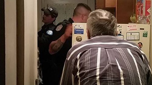 The officers stocking the fridge. (Brian Gray, Facebook)