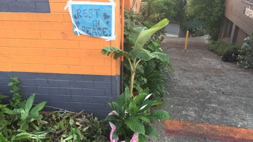 Flowers and candles left for the 47-year-old woman killed in the crash in Rozelle. (Chris O'Keefe, 9NEWS)