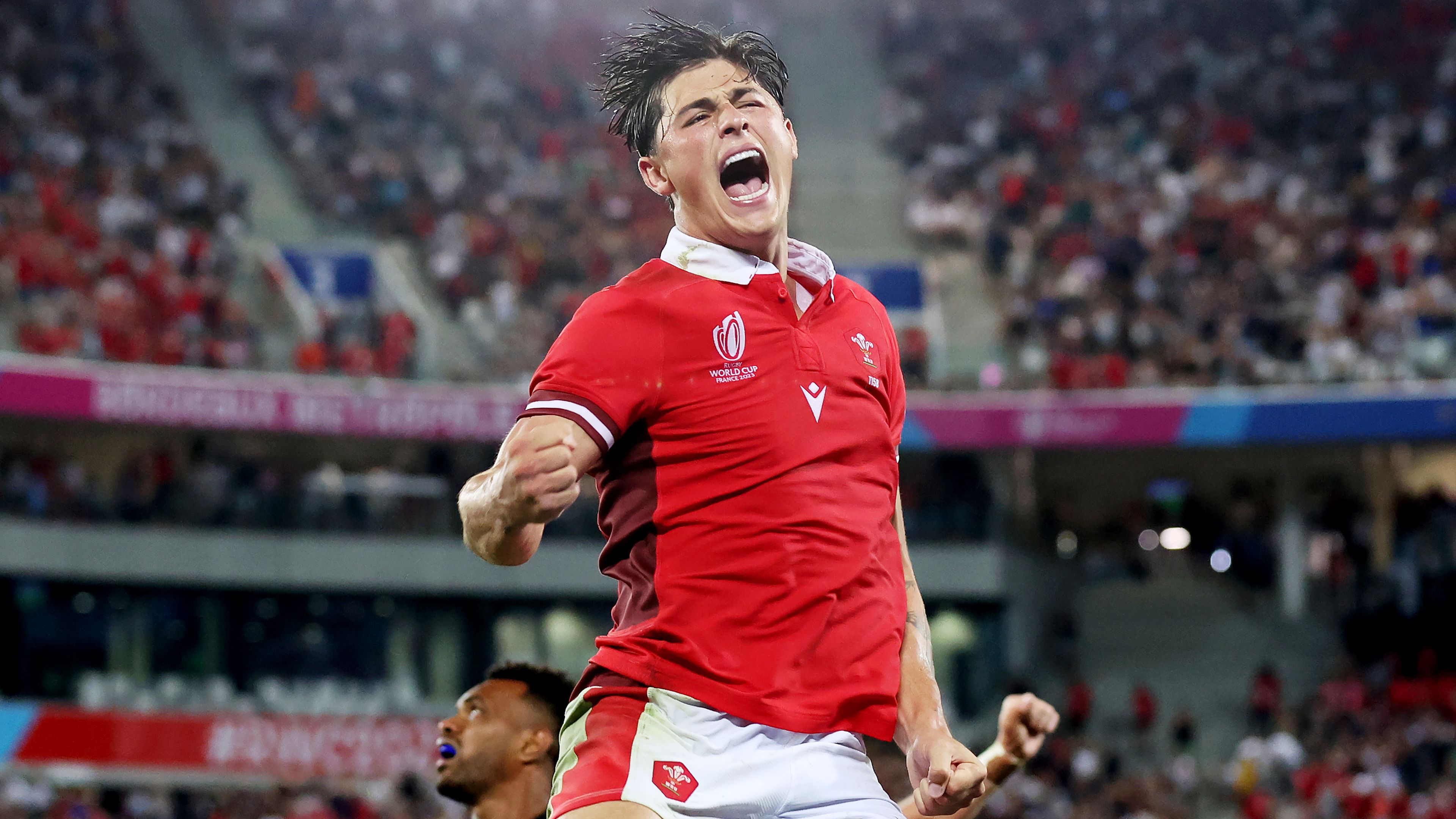 Louis Rees-Zammit of Wales celebrates victory at the final whistle.