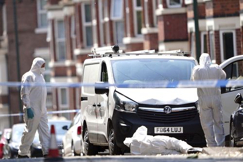 Police forensics officers search a white van on the corner of Maples Street and Bentinck Road in Nottingham, as three people have been found dead in the city in what police described as a "horrific and tragic incident".  