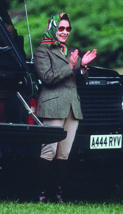 Queen Elizabeth ll, wearing jodhpurs and a headscarf, relaxes during Windsor Horse Show  on May 13, 1988 in Windsor, England. (Photo by Anwar Hussein/Getty Images)