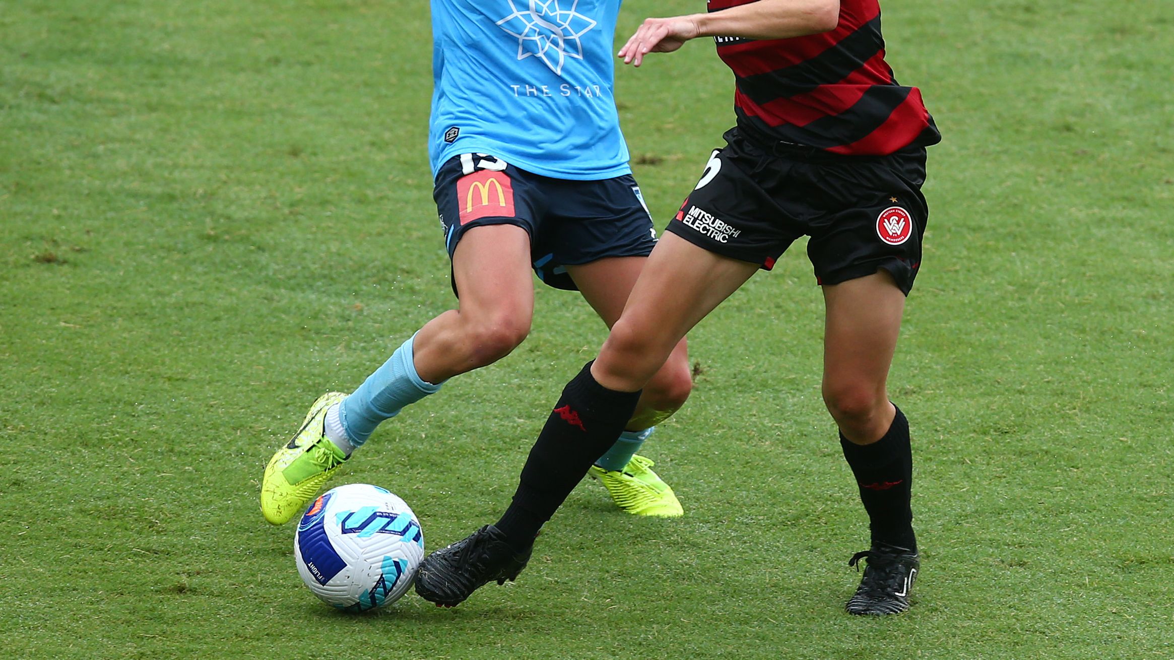 Mackenzie Hawkesby of Sydney FC and Olivia Price of the Wanderers compete for the ball.