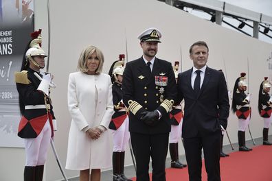 French President Emanuel Macron, right, and his wife Brigitte Macron, welcome Norway's Crown Prince Haakon 