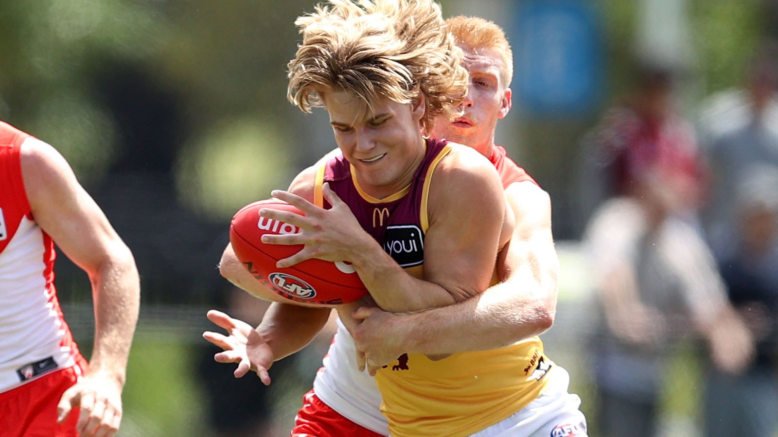 Will Ashcroft of the Lions competes with Jordan Dawson of the Swans during an AFL match simulation.