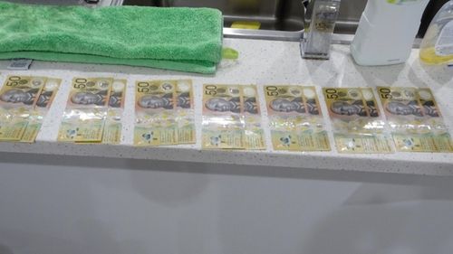 Cash seized during a police raid as part of an investigation into money laundering through cryptocurrency.