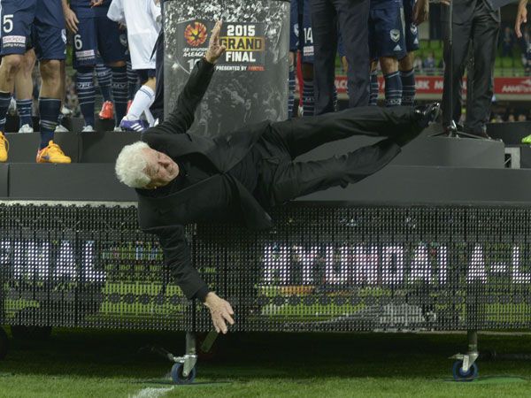Frank Lowly falls off the dais at the A-League grand final. (AAP)