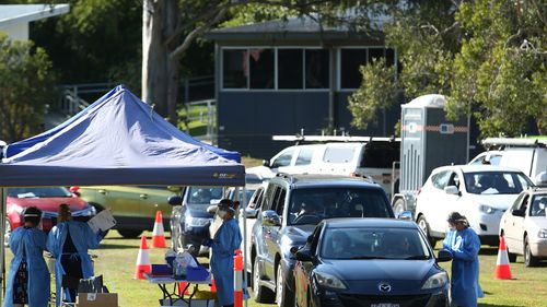 Residents are tested for COVID-19 at a pop up testing clinic at Indooroopilly State High School, in Brisbane.