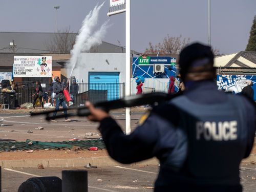 Police fired rubber bullets at dozens of looters as they ran from a mall with everyday items, while other shops in the vicinity were set ablaze.