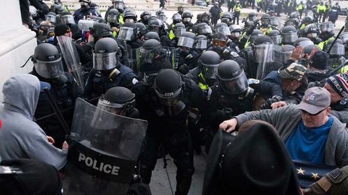 U.S. Capitol Police push back rioters trying to enter the Congress building.