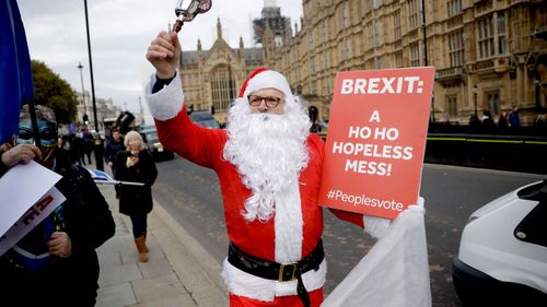 A demonstrator dresses as Santa Claus to protest Brexit outside London's Houses of Parliament.