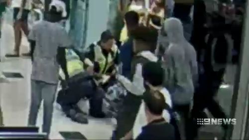 Officers are seen arresting a teenager before the attack.