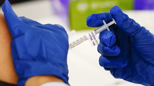 FILE - A health worker administers a dose of a Moderna COVID-19 vaccine during a vaccination clinic in Norristown, Pa. on Dec. 7, 2021. In a reversal for President Joe Biden, a federal appeals court in New Orleans on Monday, June 27, 2022, agreed to reconsider its own April ruling that allowed the administration to require federal employees to be vaccinated against COVID-19. (AP Photo/Matt Rourke, File)