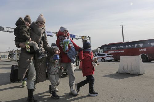 Refugees from Ukraine cross into Poland at the Medyka crossing, Tuesday, March 1, 2022. 