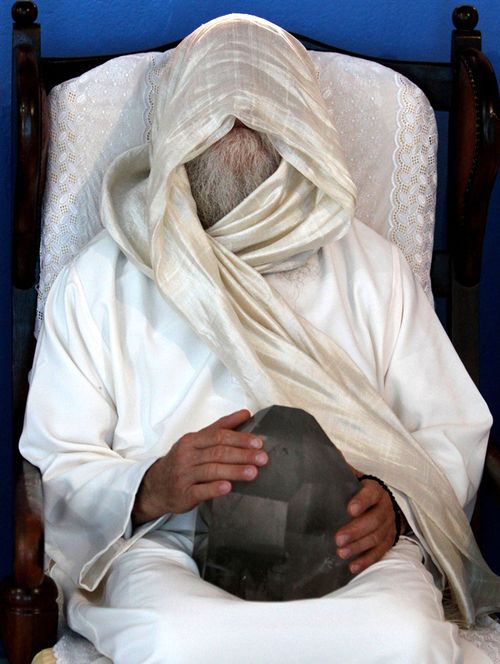 A medium holds a crystal during a healing ceremony at the Casa de Dom Inacio de Loyola in Abadiania, in the state of Goias, Brazil. 