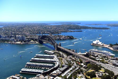 An aerial image shows North Sydney, Sydney Harbour Bridge and the Sydney Opera House.