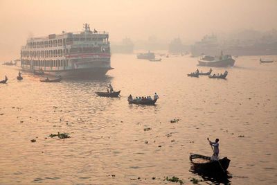 After the lull of the night, traffic resumes on the Buriganga River in Dhaka (Bangladesh, 2014).