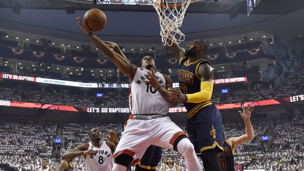 DeMar DeRozan hits the basket under the attention of LeBron James. (AAP)