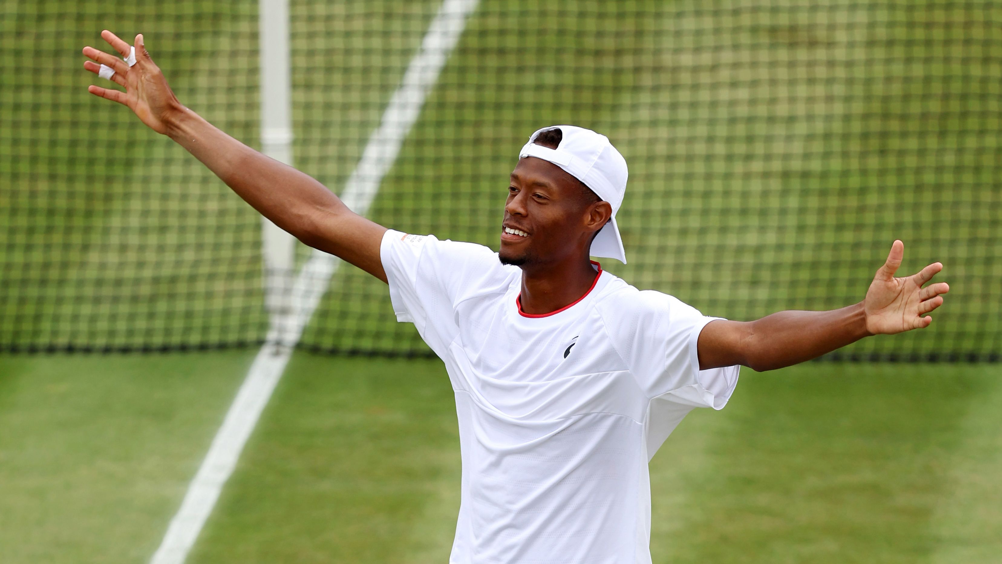 Christopher Eubanks of the United States celebrates victory against Stefanos Tsitsipas of Greece in the fourth round at Wimbledon.