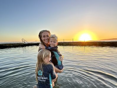 Jenna-Lea Clark and her children Summer and Van pose in their Surfebruary gear.