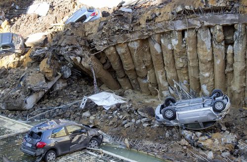  Cars are towed away after a sinkhole that opened up at the via Livio Andronico, (AP)