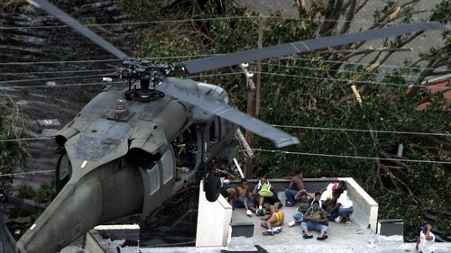 FILE - In this Sept. 1, 2005 file photo, Residents are rescued by helicopter from the floodwaters of Hurricane Katrina  in New Orleans. Hurricane Ida looks an awful lot like Hurricane Katrina, bearing down on the same part of Louisiana on the same calendar date. But hurricane experts say there are differences in the two storms 16 years apart that may prove key and may make Ida nastier in some ways but less dangerous in others.(AP Photo/David J. Phillip, Pool, File)