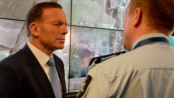 Prime Minister Tony Abbott is briefed on MH17 crash site by Assistant AFP commissioner Michael Outrim. (AAP)