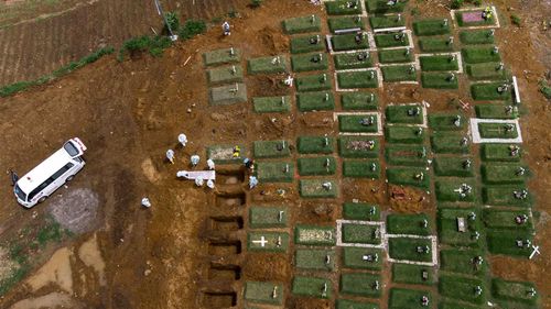 Coffins are buried at an expanding cemetery in Sumatra, Indonesia.