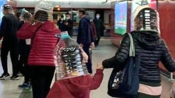 Travellers use plastic bottles and helmets as protection from coronavirus