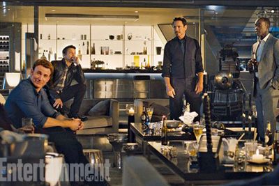 The shot gives us a first glimpse of Don Cheadle in the film as James Rhodes...enjoying a beer with Steve Rogers (Chris Evans), Clint Barton (Jeremy Renner) and Tony. Apparently even superheroes get a night off!