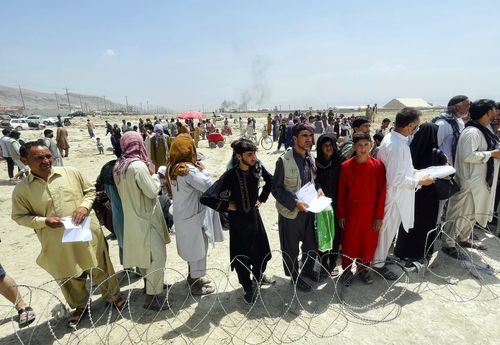 In this August 17  file photo hundreds of people gather outside the international airport in Kabul, Afghanistan. 