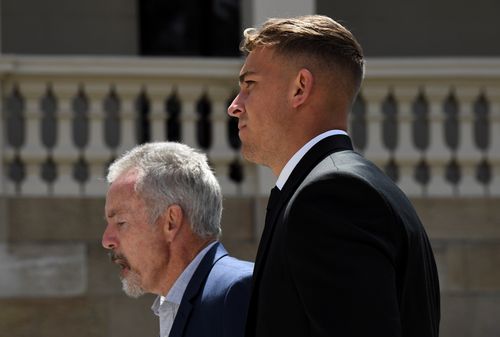 Callan Sinclair (right) arrives back at Wollongong court after the lunch break today.