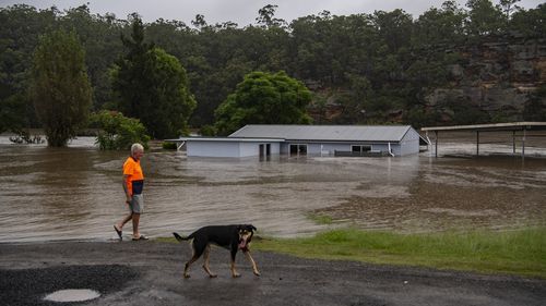 Ken Anderson inspects the inundated sites at Ulibawn Ski Park in Sackville North, near the Hawkesbury River. 