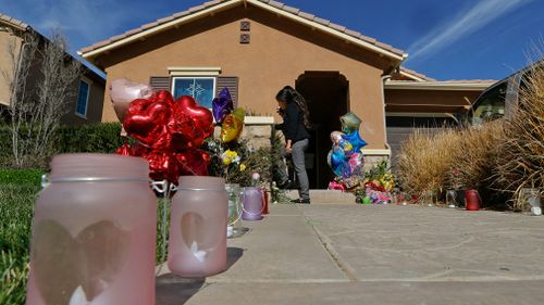 Neighbours write down messages of support for the Turpin's children on the front door of the home of David and Louise Turpin. (AAP)