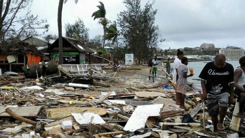 Locals sift through rubble from Cyclone Pam in Port Vila, Vanuatu. (AAP)