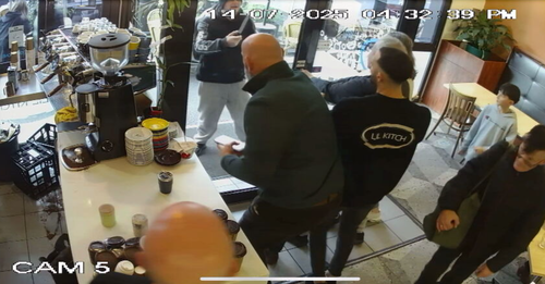 Cafe patrons were forced to hold the front door shut as a knife-wielding man attempted to gain access.