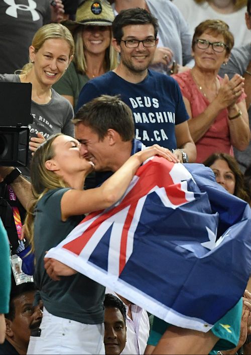 Brandon Starc celebrates his gold with girlfriend Laura Turner. (AAP)