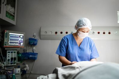 Young doctor preparing patient for surgery