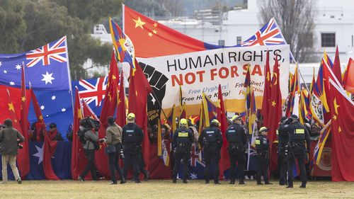 Protestors and pro-China supporters on the front lawn of Parliament House