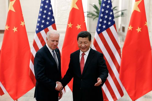 Chinese President Xi Jinping, right, shakes hands with cVice President Joe Biden