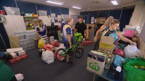 Locals and businesses donating hundreds of presents under the tree for flood-affected children, including soccer balls, skateboards, drones and gift vouchers among the haul.