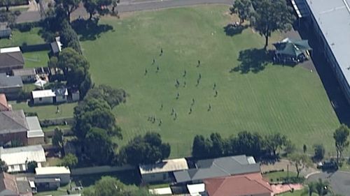 Officers search the school. (9NEWS)