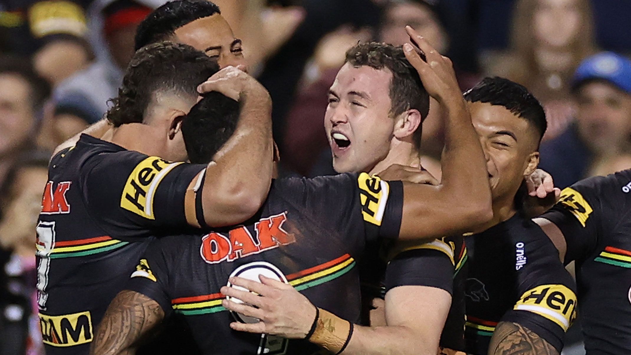 Dylan Edwards celebrates a try with panthers teammates.