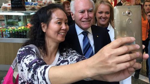 John Howard campaigning in Penrith yesterday with Liberal MP Fiona Scott (right). (AAP)