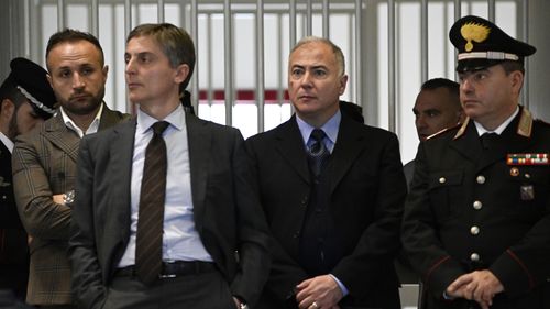 Officials listen as judges read the verdicts of a maxi-trial of hundreds of people accused of membership in Italy's 'ndrangheta organized crime syndicate