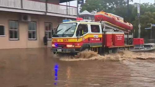Swiftwater rescue crews have rushed down the street of Laidley as the town was swamped with floodwater.