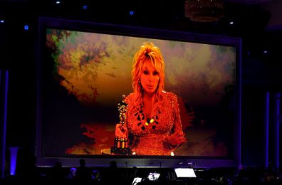 HOLLYWOOD, CALIFORNIA - NOVEMBER 16: Dolly Parton accepts an Academy Honorary Award via video during the 16th Governors Awards at The Ray Dolby Ballroom on November 16, 2025 in Hollywood, California. (Photo by Kevin Winter/Getty Images)