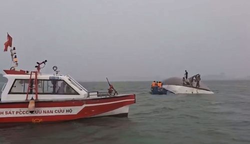 A search party searches Ha Long Bay after a tourist boat capsized.