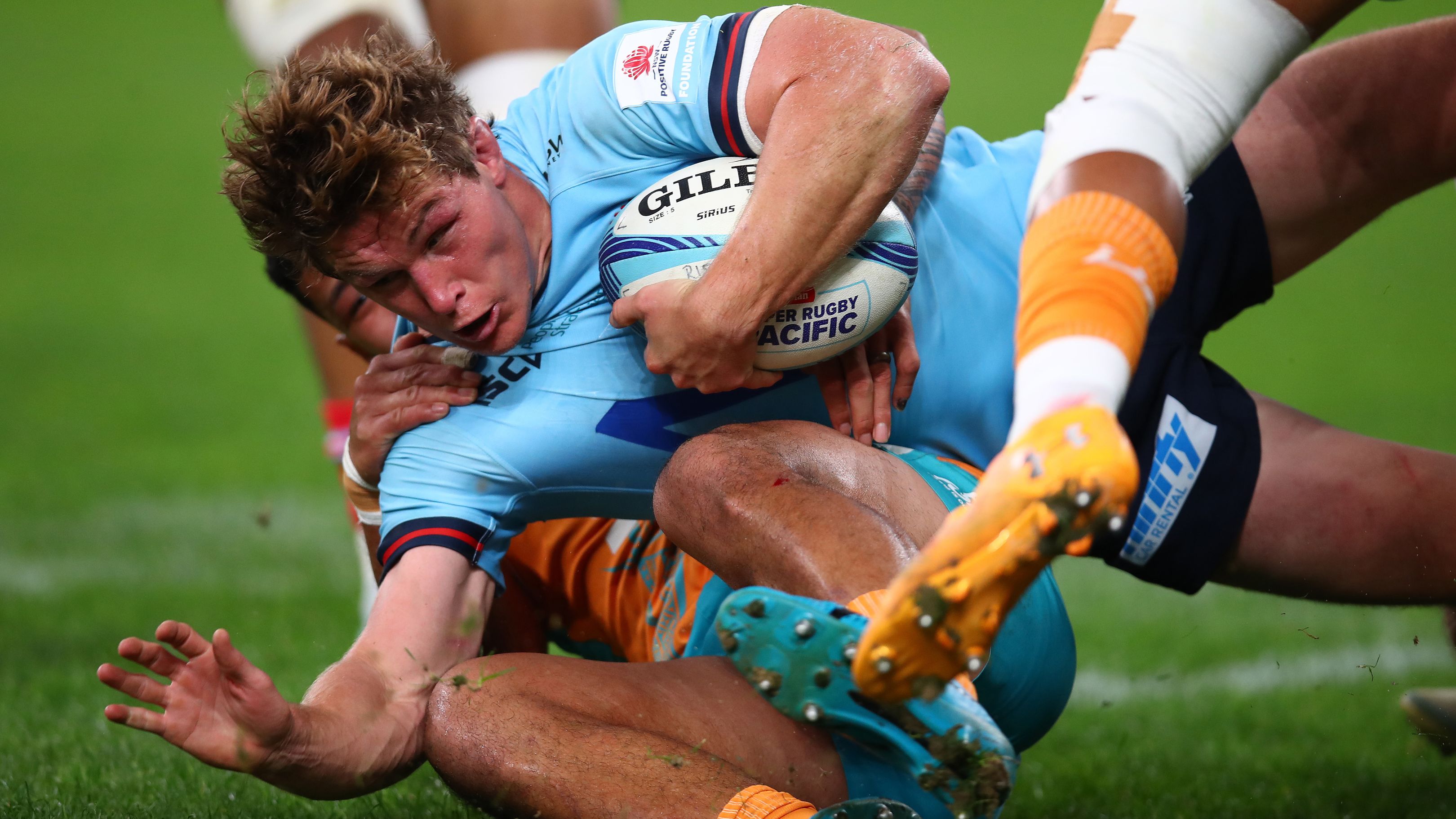 Michael Hooper of the Waratahs is tackled at Allianz Stadium.