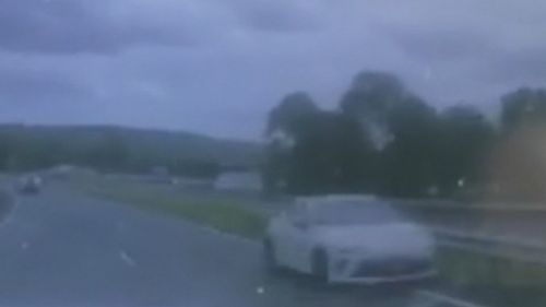 The coupe was seen on dashcam travelling the wrong way down a highway. (9NEWS)