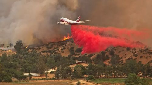 A water bomber dumping retardant on the Hillville fire near Nabiac. 